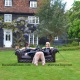 The Baroness Essex and Mistress Troy relax on a serene lawn in England