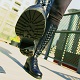 Under Mistress Troy's black leather boot