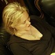 Dominatrix Mistress Troy lounging in Her New York City dungeon in red leather boots