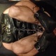 Balled-up bondage slave with leather and chains